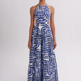 Woman wearing a blue and white patterned dress on a white background