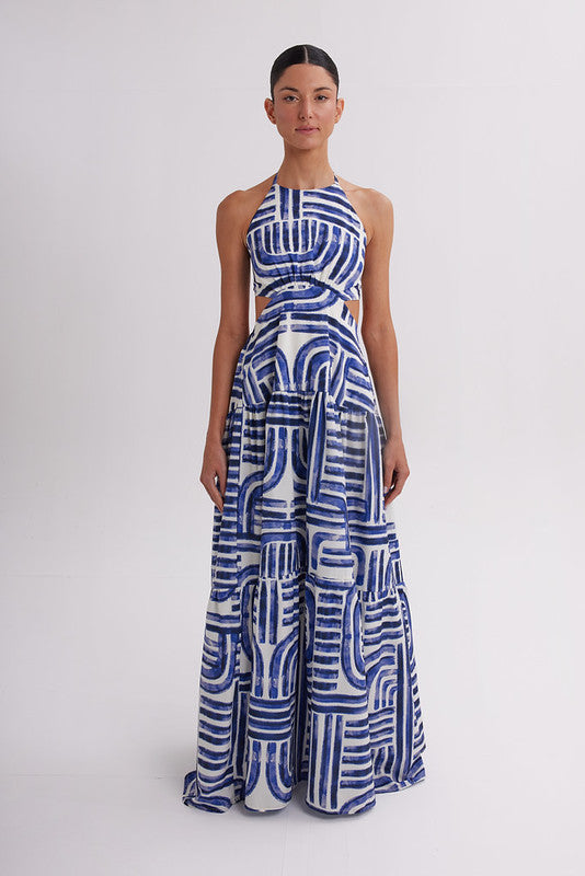 Woman wearing a blue and white patterned dress on a white background