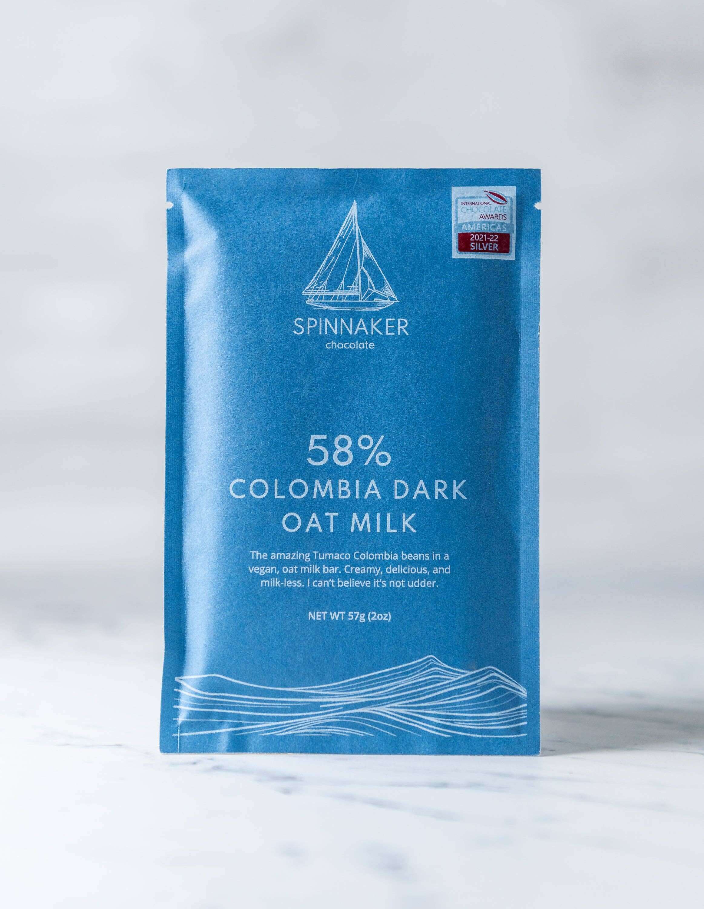 Blue Spinnaker chocolate bar packaging on a white background.