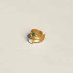 Gold ring with colorful gemstones on a white background.