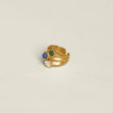 Gold ring with colorful gemstones on a white background.