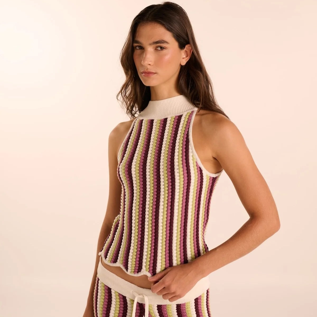 Woman wearing a hand-knit pant and shirt set. Available at EVAMAIA boutique in Studio City.