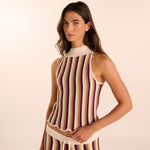 Woman wearing a hand-knit pant and shirt set. Available at EVAMAIA boutique in Studio City.