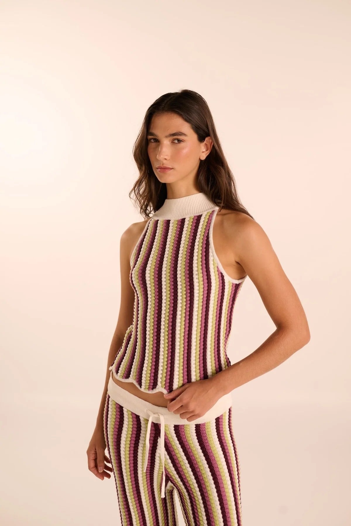 Woman wearing a hand-knit pant and shirt set. Available at EVAMAIA boutique in Studio City.