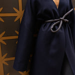 Model wearing a coat and a black belt