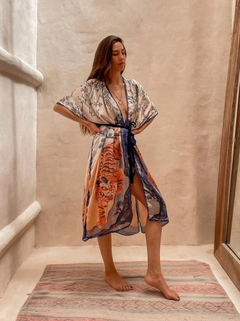 Woman wearing a floral and tiger print kimono.  