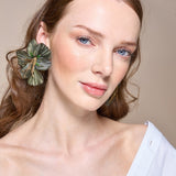 Woman with a floral hair accessory against a neutral background