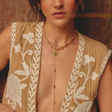Woman wearing a delicate gold lariat necklace with amber crystal drop, handmade in Medellín Colombia