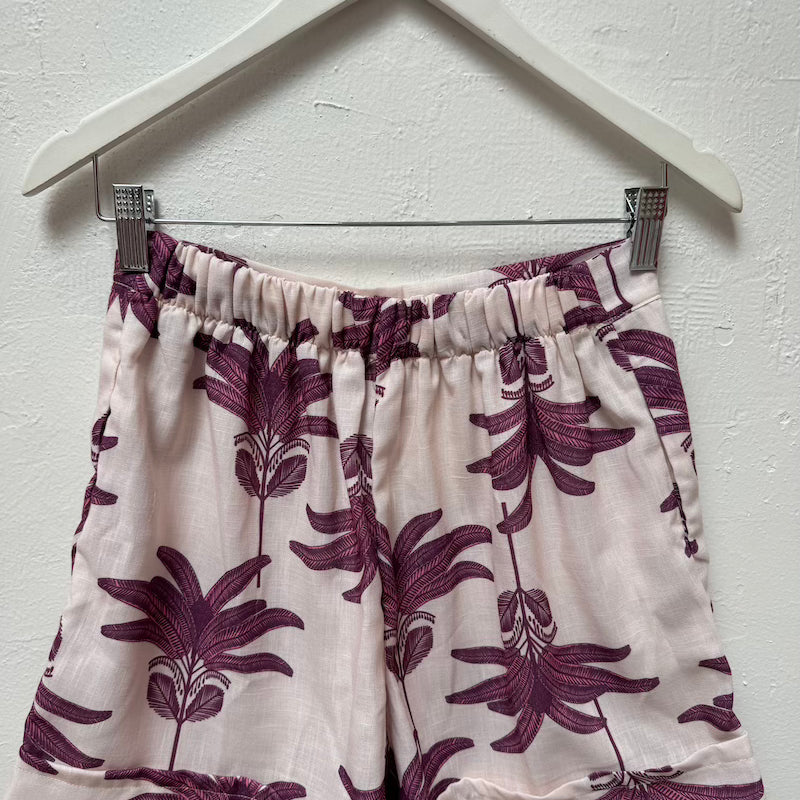 Image of the back view of the Claudette shorts by Mar de Lua. These shorts are on a hanger. The purpose of this image is to highlight the shorts.