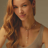 Woman wearing a pearl necklace with a neutral background
