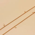 Long natural pearl necklace with 24k gold plating tied at chest, handmade in Colombia