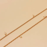 Long natural pearl necklace with 24k gold plating tied at chest, handmade in Colombia