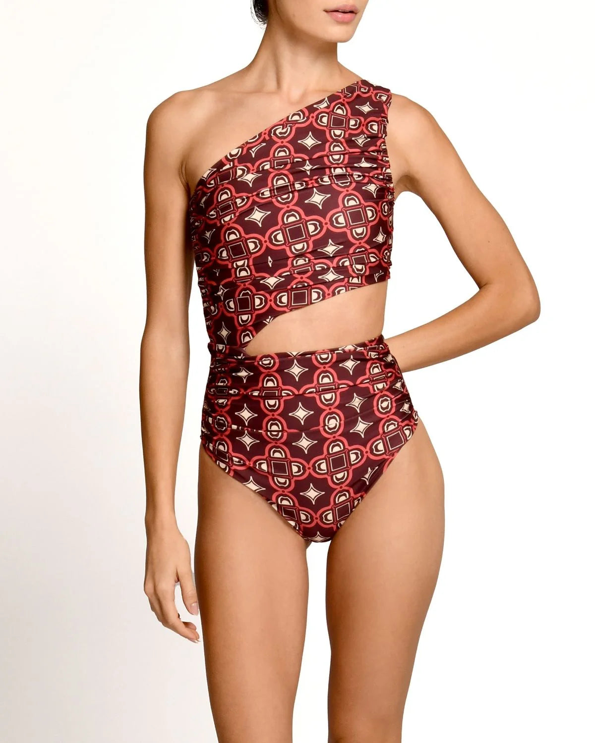 Red and black patterned one-shoulder swimsuit on a model against a white background