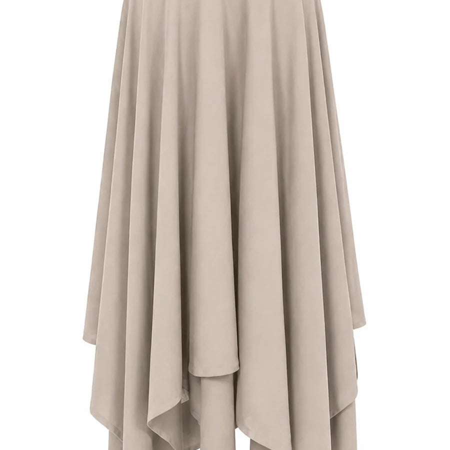 A high-waisted, flowing midi skirt in a light taupe-beige color, featuring an asymmetrical layered hemline, shown against a plain white background.