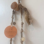 Decorative necklace with natural silver elements on a light background