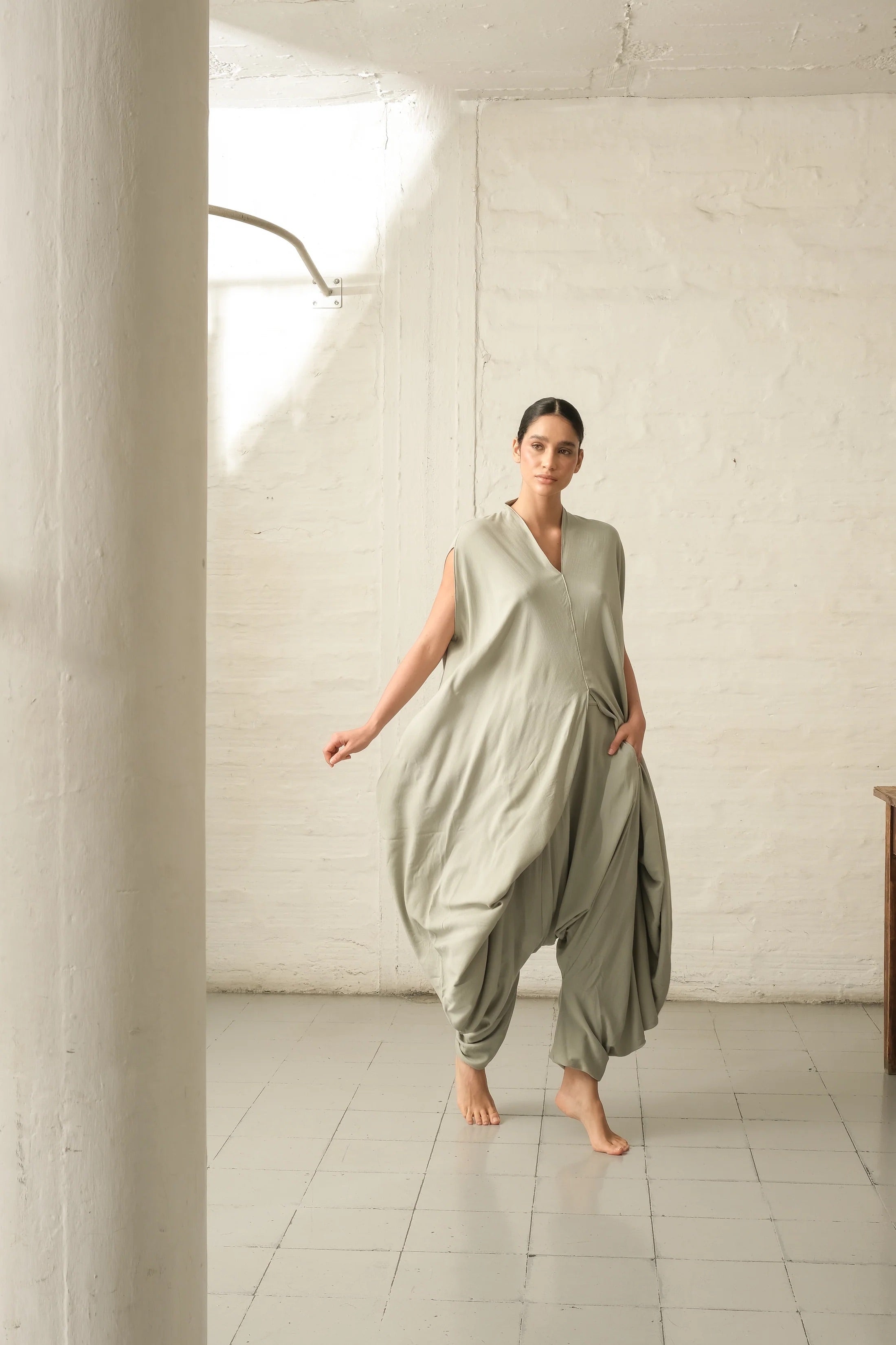 model wearing a mint green jumpsuit - this is used to sell the jumpsuit, which is elegant, yet flowy and comfortable.