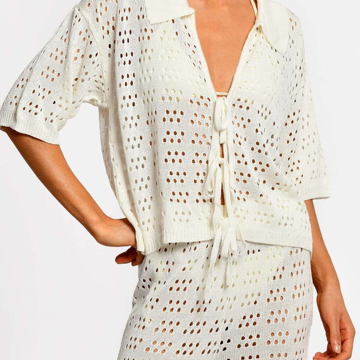 Matching white crochet top and pants on a white background.