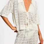 Matching white crochet top and pants on a white background.