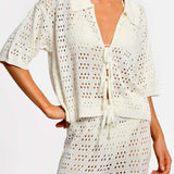 Matching white crochet top and pants on a white background.