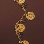 Gold necklace with animal charm pendants on a brown background