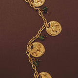 Gold necklace with animal charm pendants on a brown background