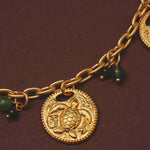 Close up of a sea turtle on a gold-plated chain necklace