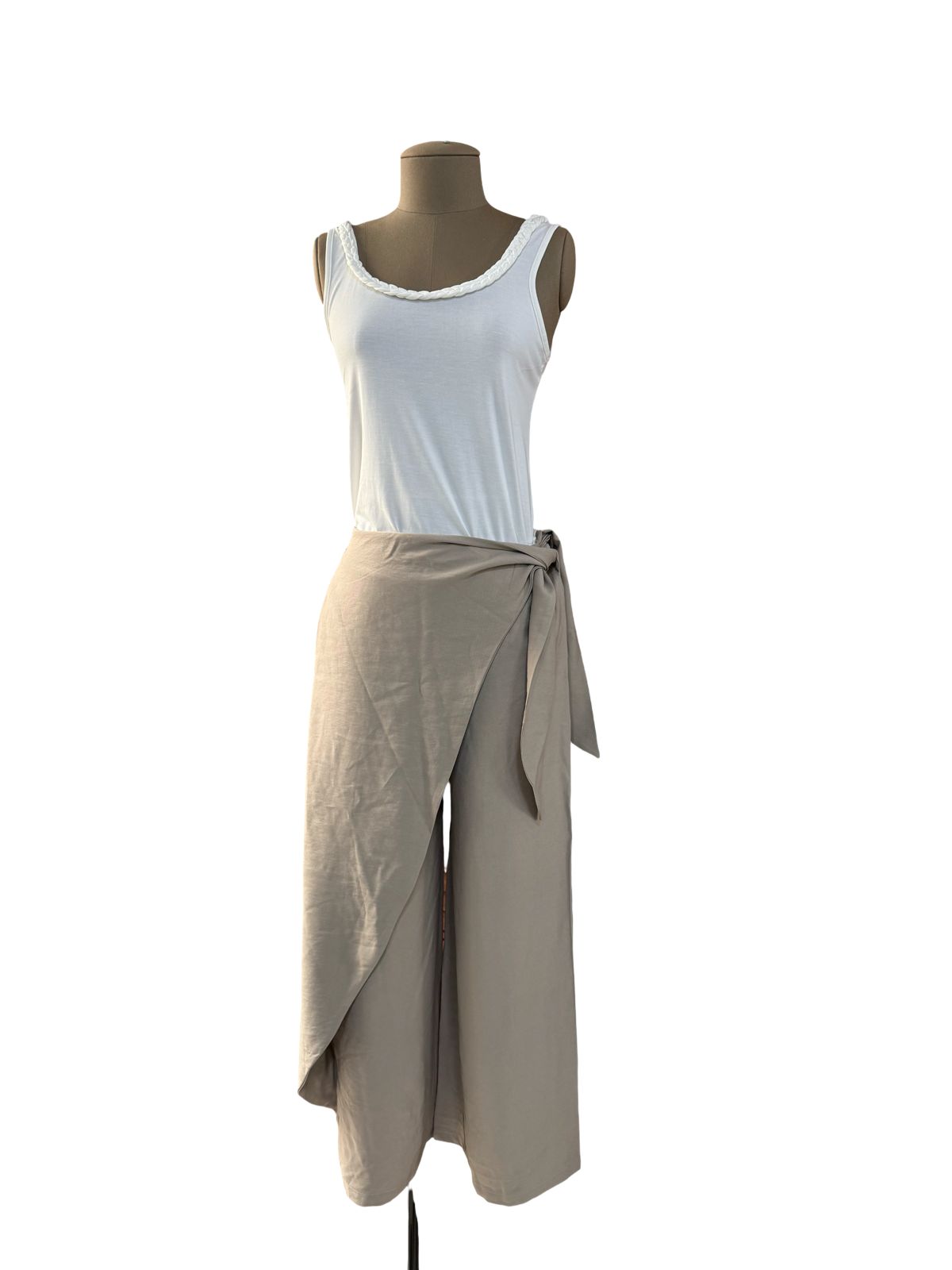 Mannequin wearing a white tank top and beige wrap skirt on a white background