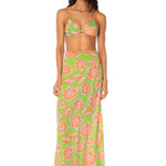 Woman wearing a floral two-piece swimsuit on a white background.