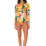 Woman wearing a colorful floral swimsuit on a white background.