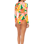 Woman wearing a colorful floral swimsuit on a white background.