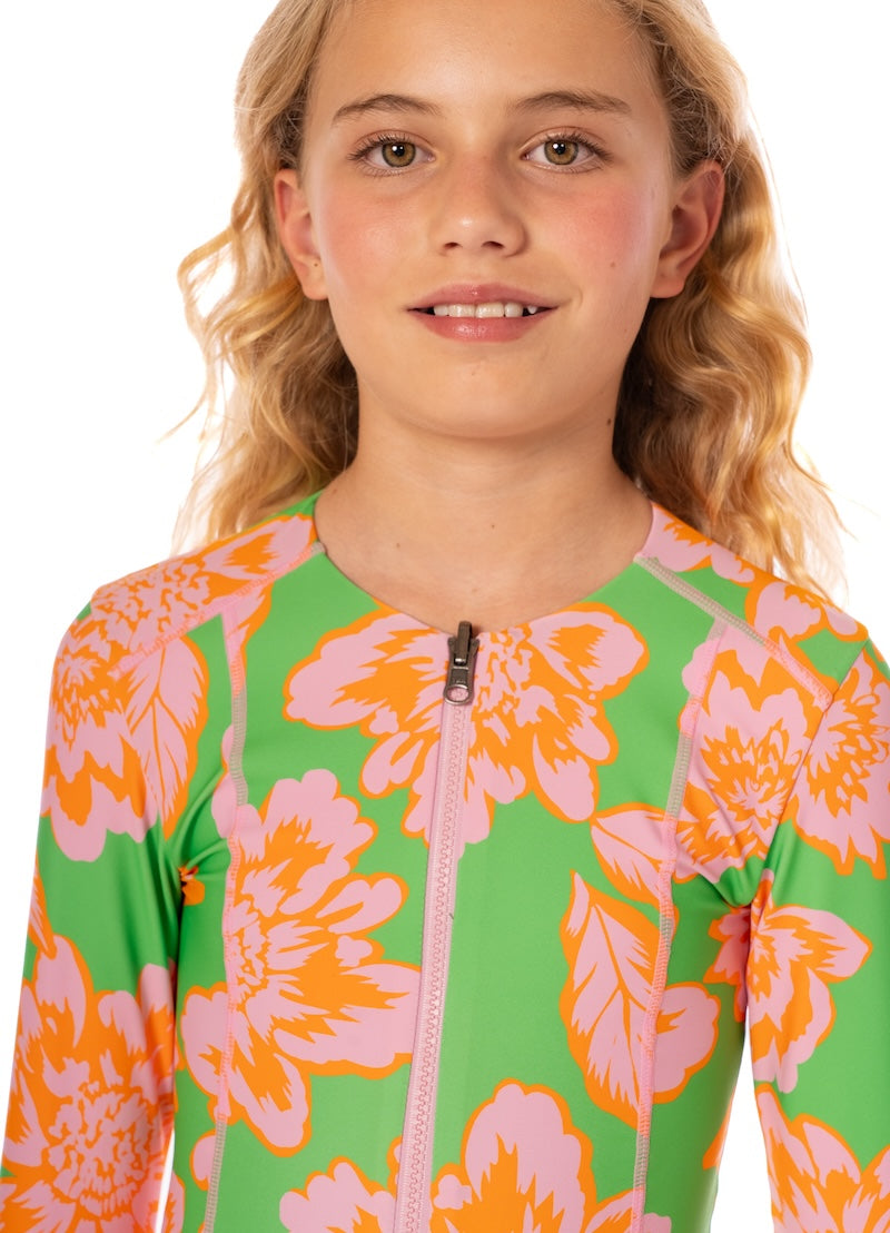 Child wearing a colorful floral swimsuit on a white background