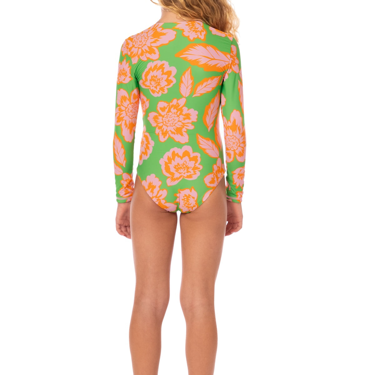 Girl wearing a green swimsuit with pink floral pattern on a white background