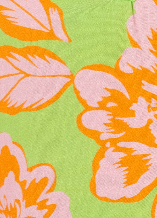 Close-up of floral pattern with orange and pink flowers on a green background