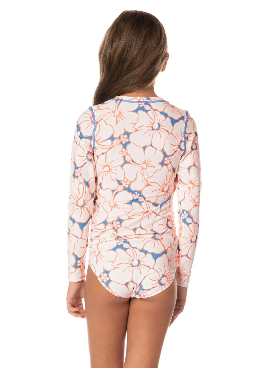 Woman wearing a floral patterned long-sleeve shirt on a white background