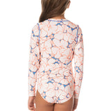 Woman wearing a floral patterned long-sleeve shirt on a white background