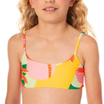 Young girl wearing a colorful bikini top with a white background