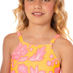 Young girl wearing a yellow floral dress with pink flowers on a white background.