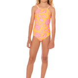 Young girl wearing a pink and yellow floral swimsuit on a white background