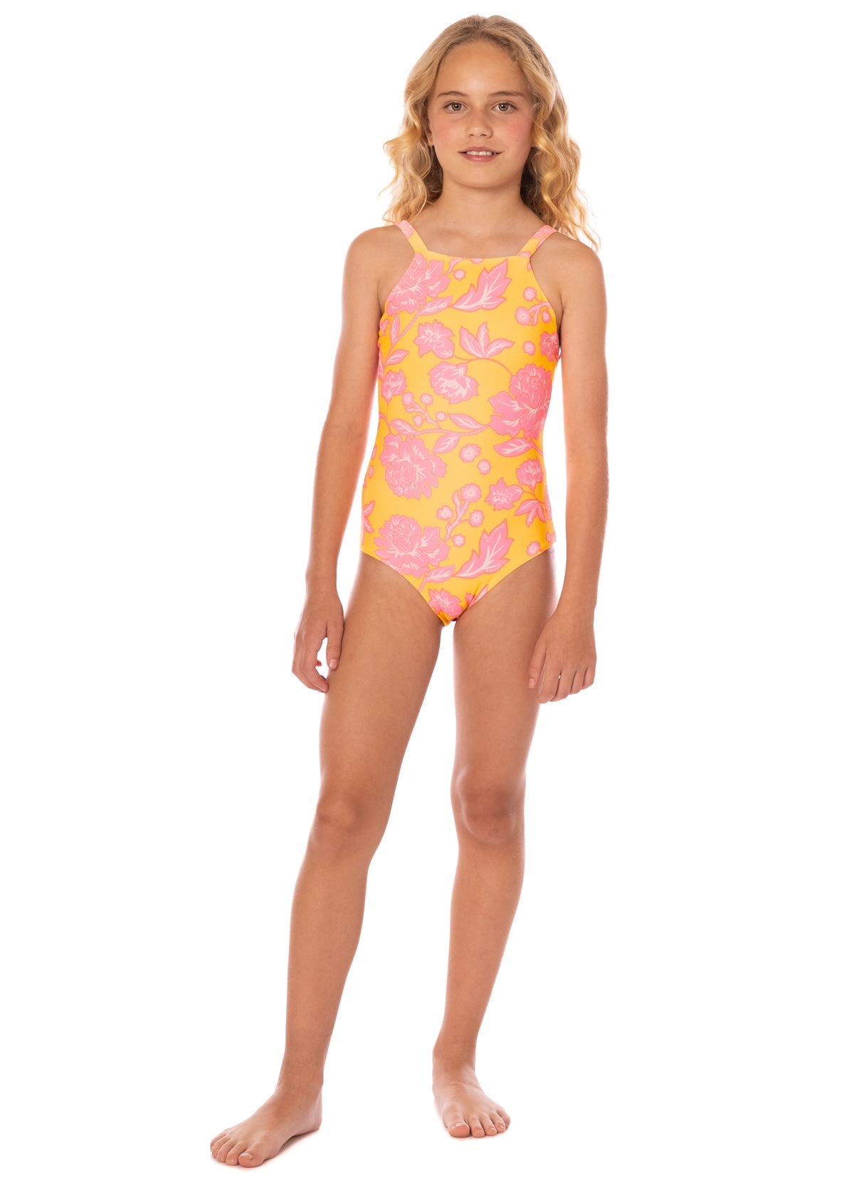 Young girl wearing a pink and yellow floral swimsuit on a white background