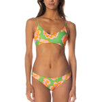 Woman wearing a colorful floral bikini on a white background.