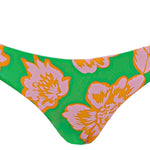 Floral-patterned bikini bottom on a green background.