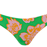 Floral-patterned bikini bottom on a green background.
