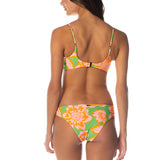 Woman wearing a colorful bikini with a white background.