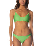Woman wearing a green bikini on a white background.