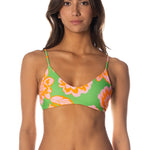 Woman wearing a colorful floral bikini on a white background.