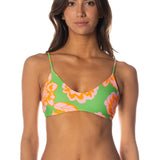 Woman wearing a colorful floral bikini on a white background.