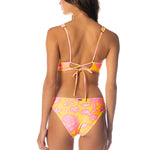 Woman wearing a colorful bikini with floral pattern on a white background.