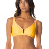 Woman wearing a yellow bikini against a white background.