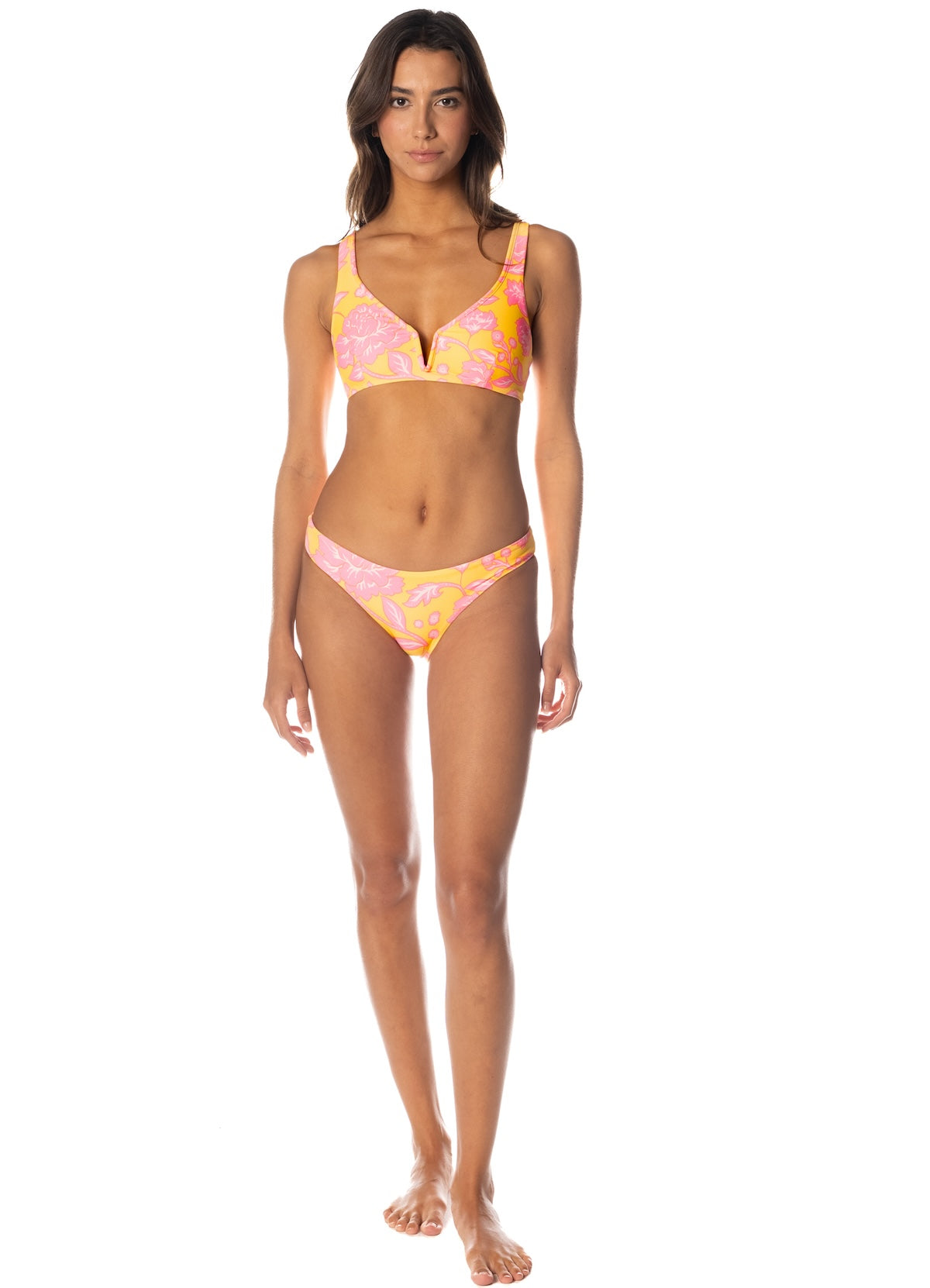 Woman wearing a colorful bikini set on a white background.