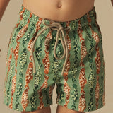 Boys green and orange fish patterned swim shorts. 